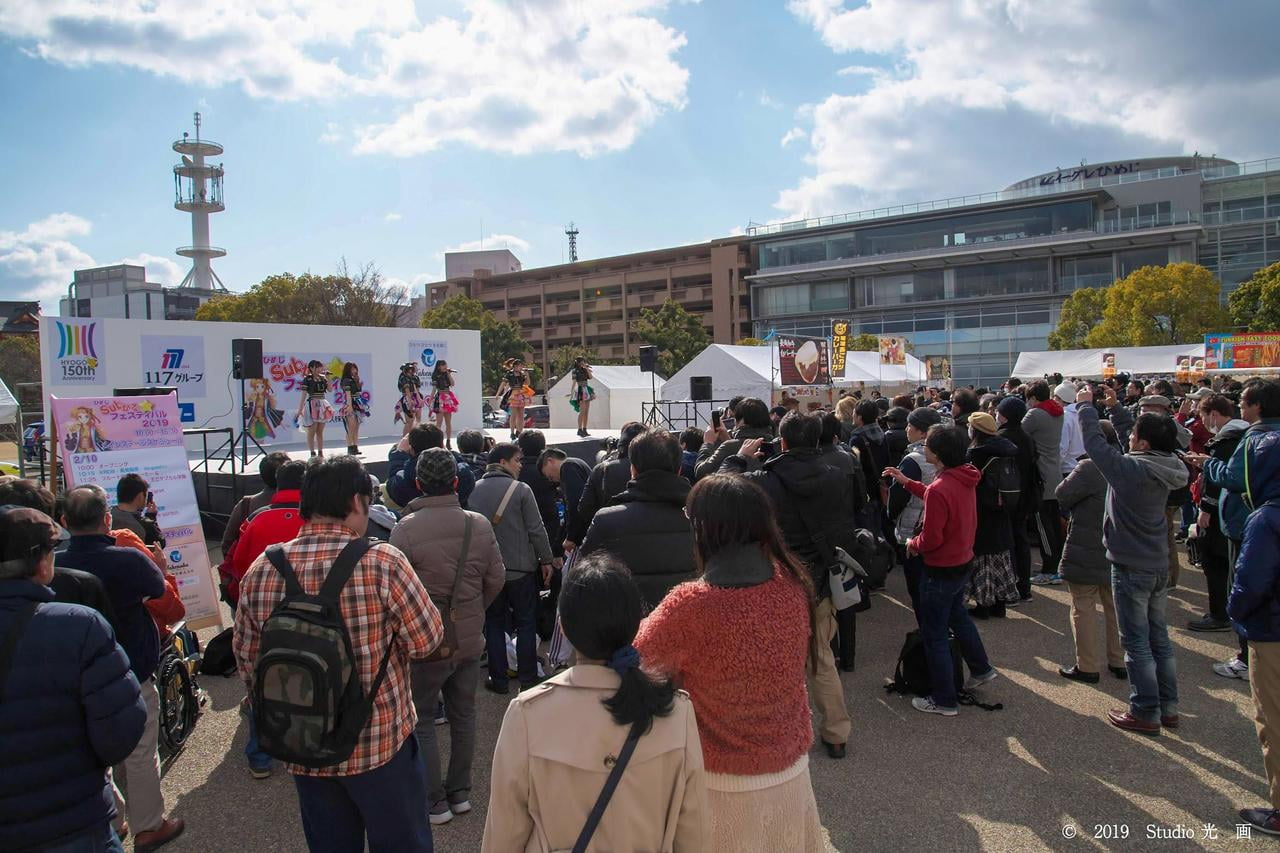 ご当地アイドルのステージイベントを観覧する人たちの写真